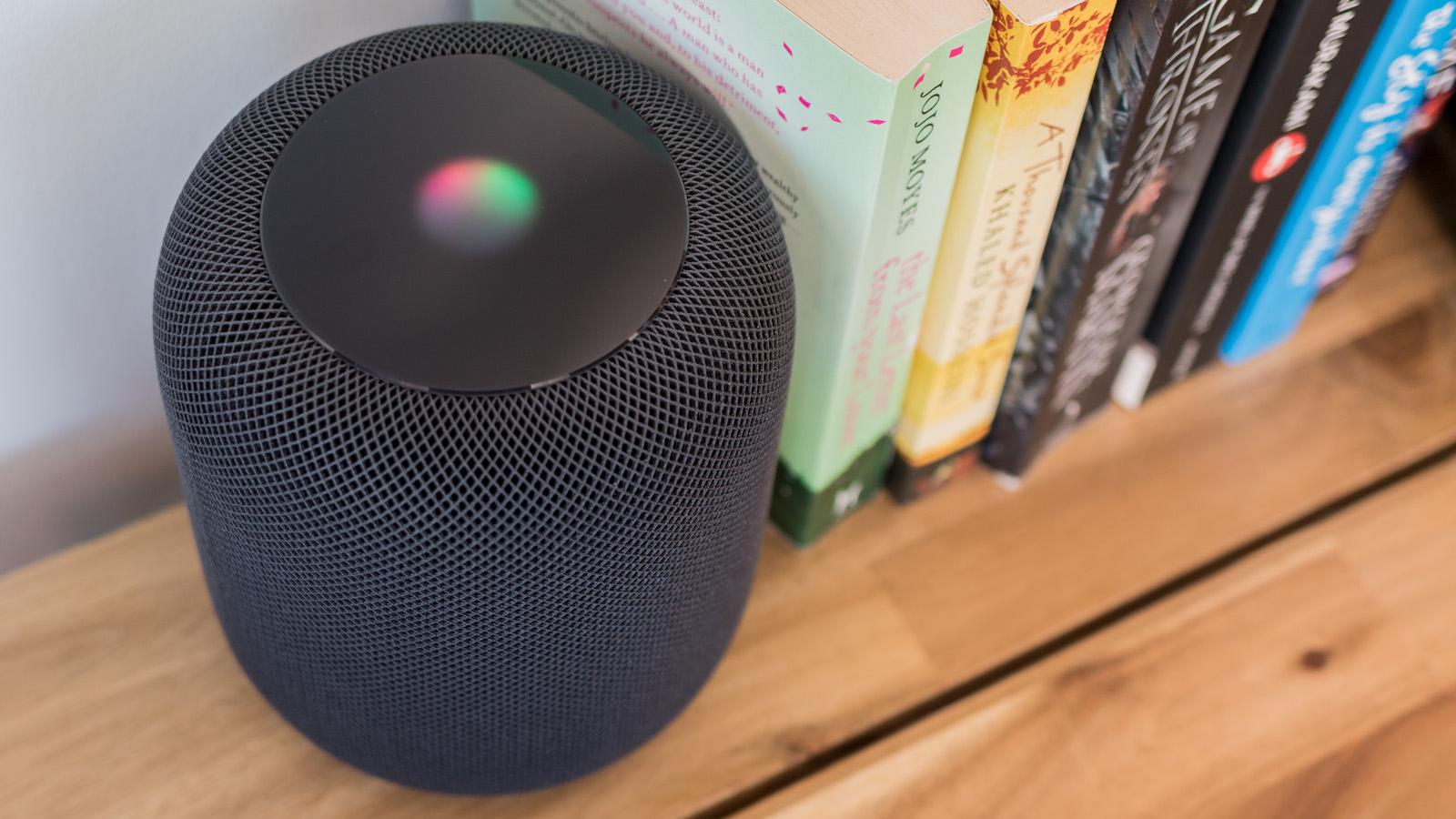 HomePod on bookshelf with screen illuminated